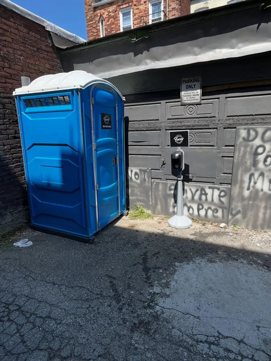 Portable toilet placed in a narrow driveway